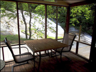 The Villa's screened in porch overlooking the waterfall